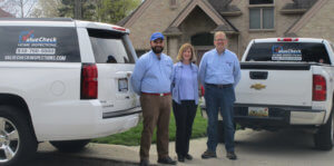 photograph of 3 members of the ValueCheck Home Inspections team outside a home